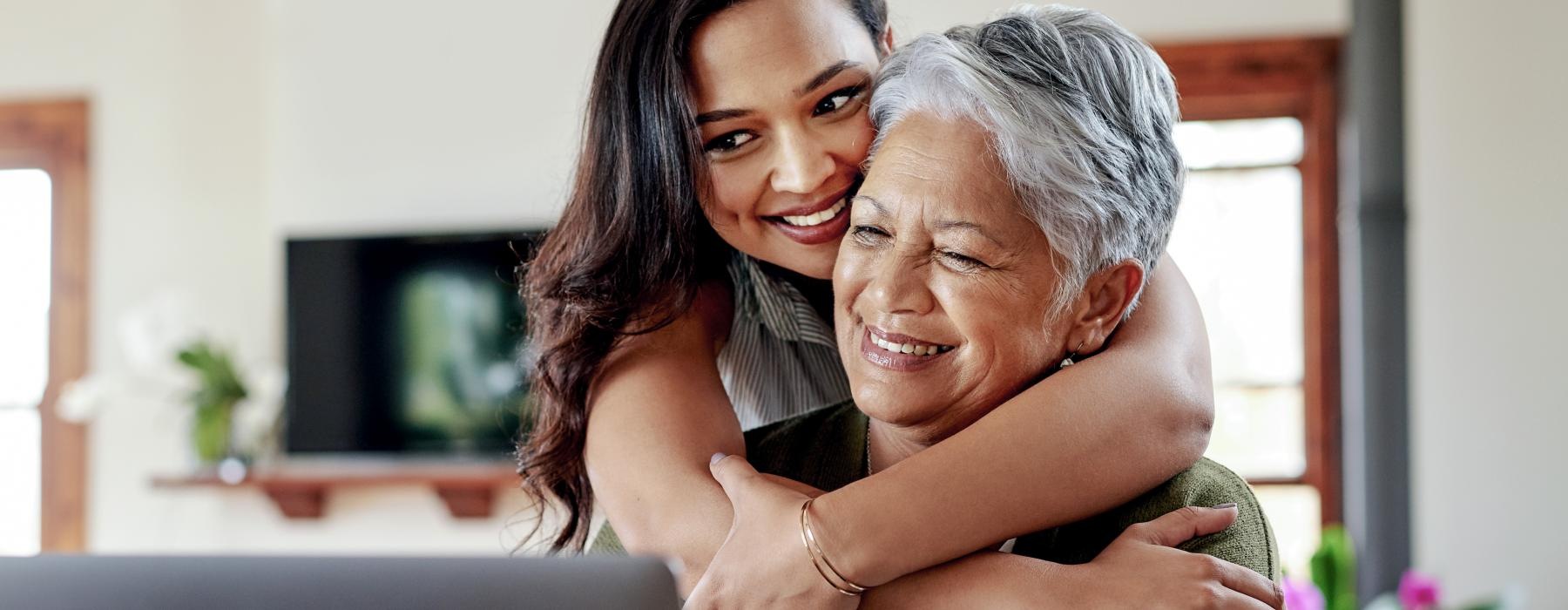 a woman and her grandmother looking at a laptop