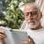 man reading a book in hammock
